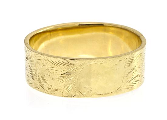 A 14 Karat Yellow Gold Hinged Bangle