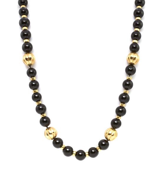 An 18 Karat Yellow Gold and Onyx