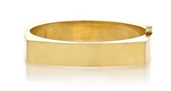 A 14 Karat Yellow Gold Hinged Bangle