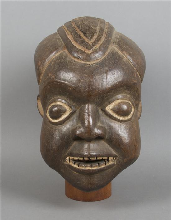 A Carved Helmet Mask Bamum depicting