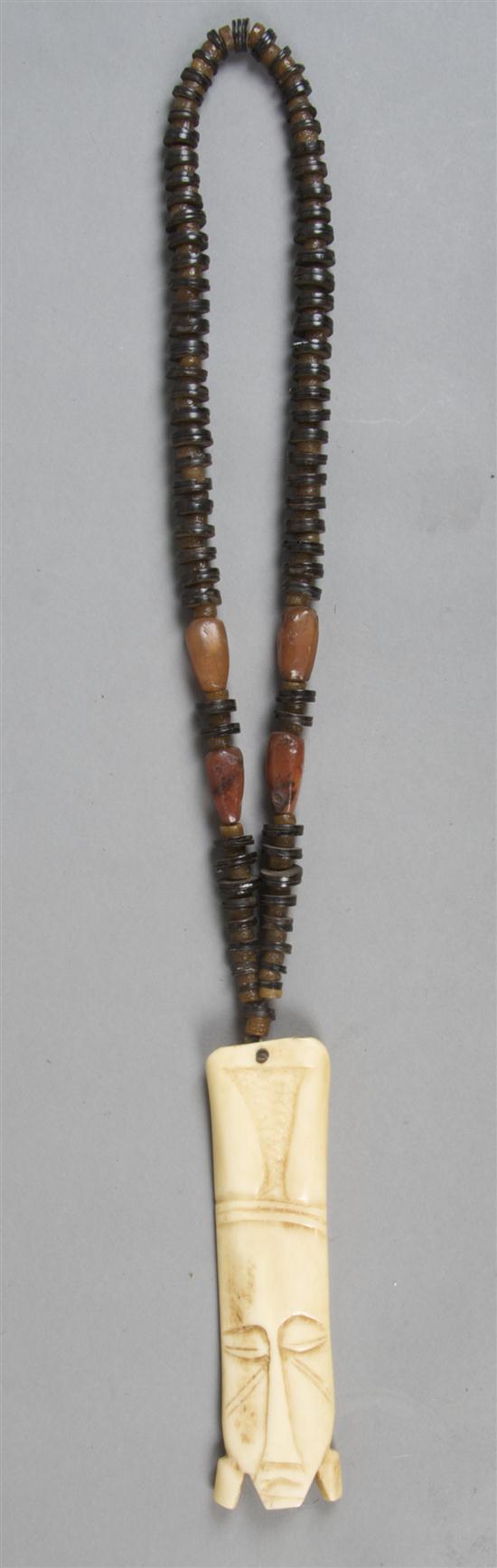 An African Carved Ivory or Bone Pendant