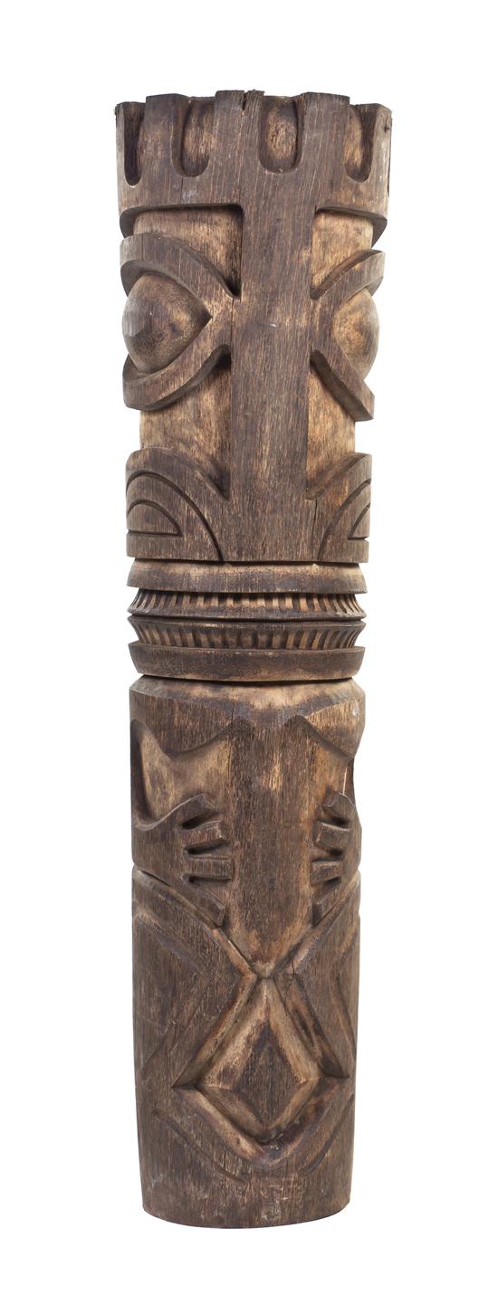 A Carved Wood Tiki Totem depicting