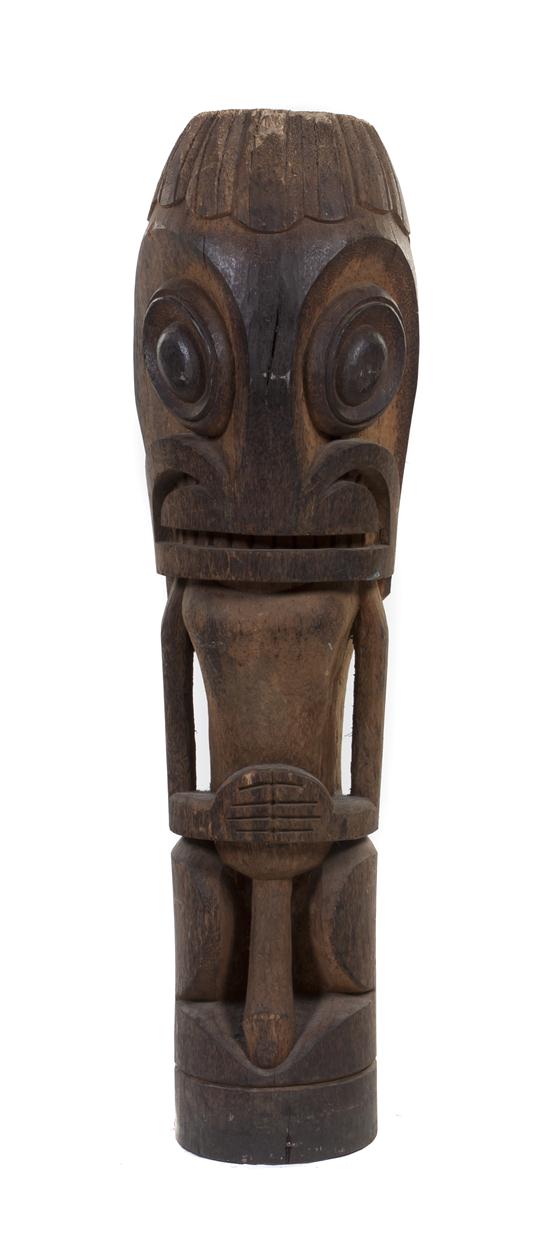 A Carved Wood Tiki depicting a