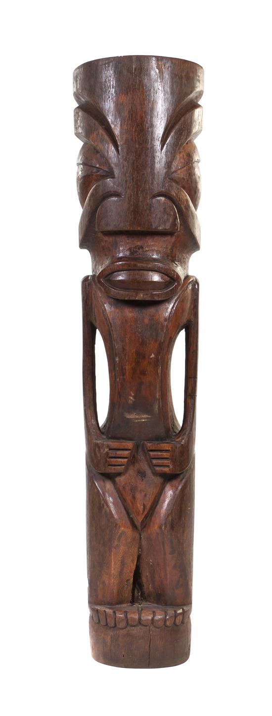A Carved Wood Tiki depicted upright