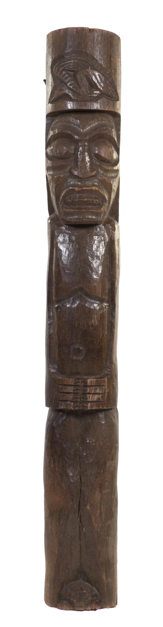 A Carved Wood Tiki Totem of cylindrical