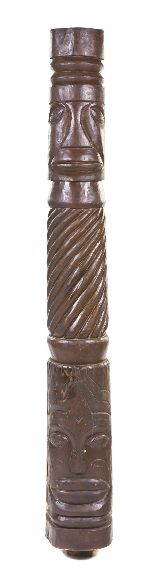 A Carved Wood Tiki Totem of cylindrical