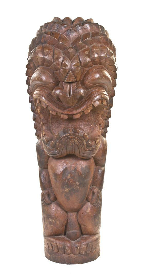 A Carved Wood Tiki depicting an