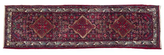 * A Persian Wool Runner with three