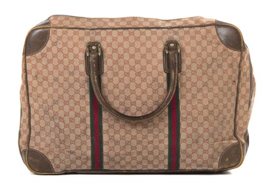 A Gucci Red Monogram Canvas Suitcase.