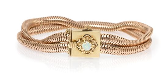 A 14 Karat Two Tone Gold and Opal Bracelet