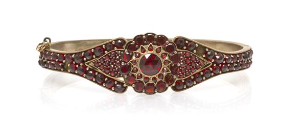 *A Gold Tone and Garnet Bangle