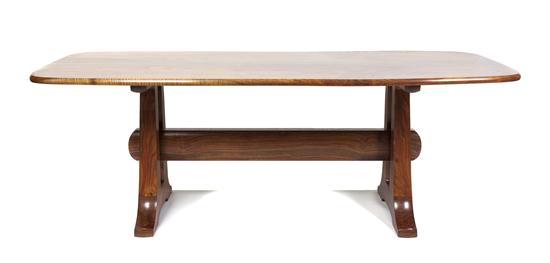 A Contemporary Wood Dining Table having