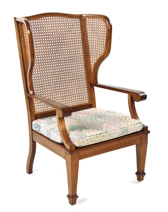 An American Caned Open Armchair having