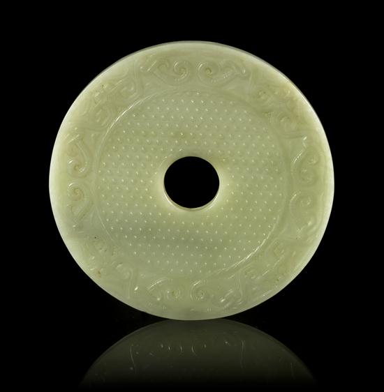A Jade Bi Disc of pale celadon