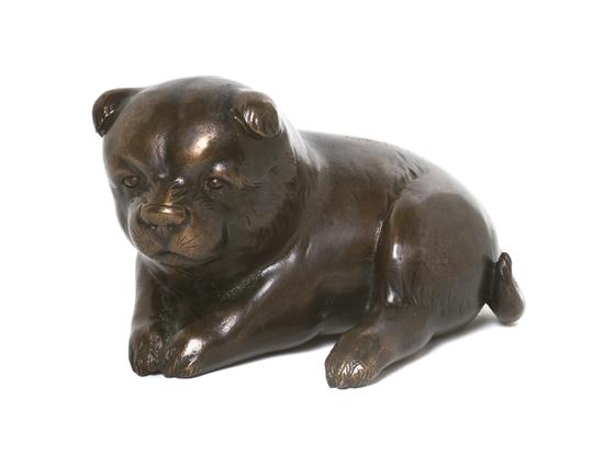 A Japanese Bronze Model of a Pup depicted