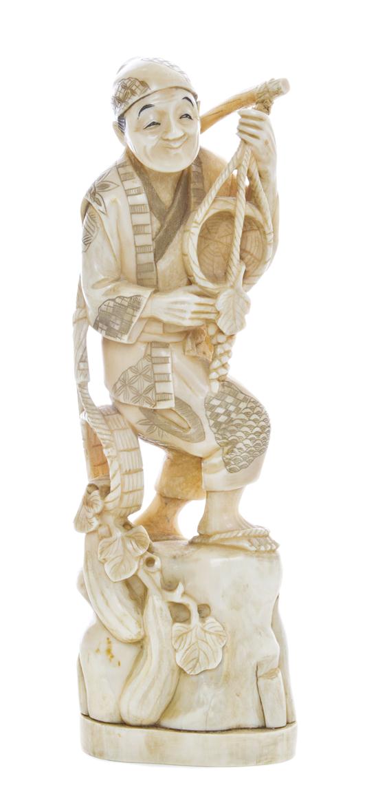 * A Japanese Carved Ivory Okimono depicting