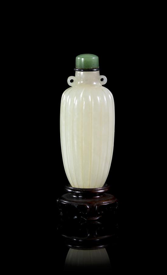 * A Carved Jade Pendant Form Snuff