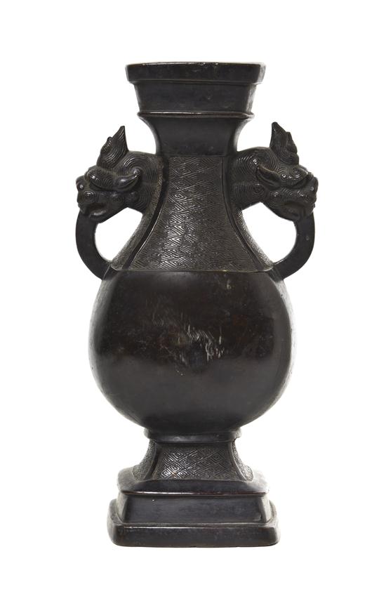 * A Chinese Bronze Vase (Fanghu) Ming