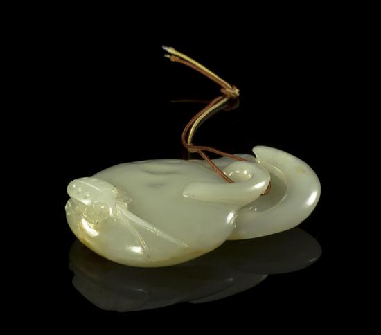 A Carved Jade Toggle of a white