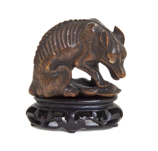 A Carved Wood Netsuke of a Wolf the