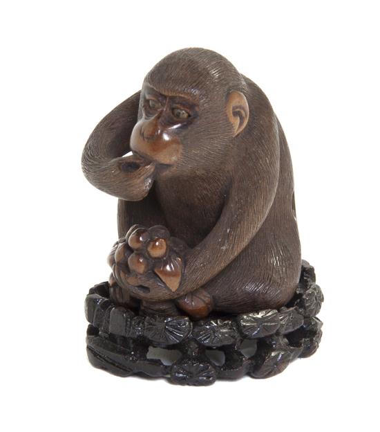 A Carved Wood Netsuke depicting