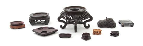 A Group of Forty-Three Carved Wood Stands.