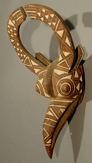 Grotesque carved African mask with