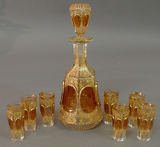 Amber cut glass decanter and seven