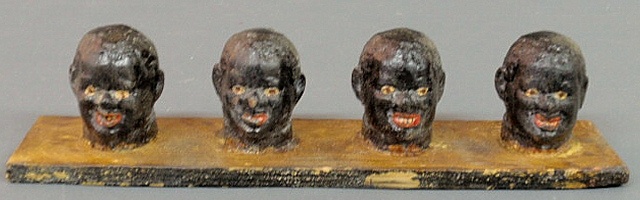 Set of four folk art carved heads