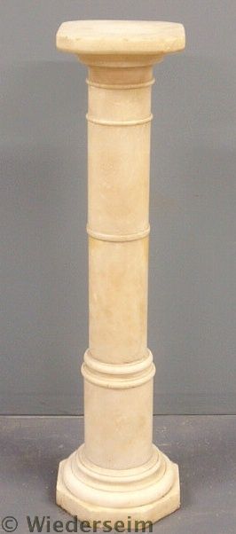 Alabaster pedestal with a rotating top.