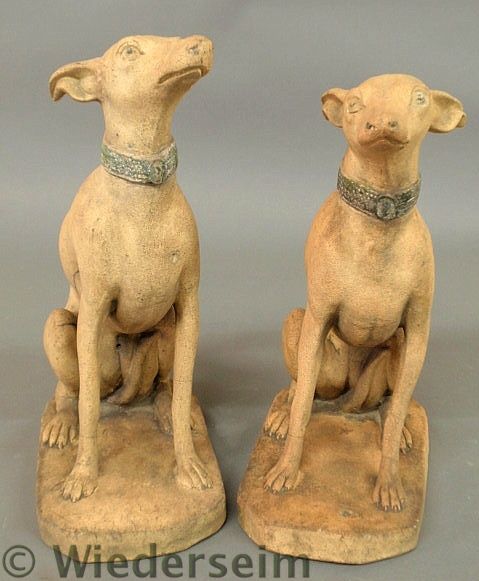 Two similar seated terracotta whippets