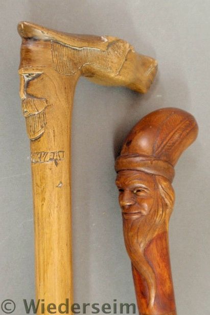 Two carved walking sticks late