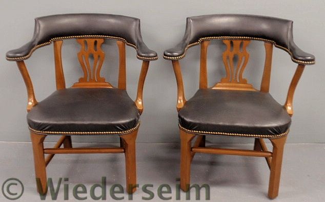 Pair of leather style barrel-back armchairs