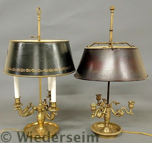 Two similar brass table lamps with flying