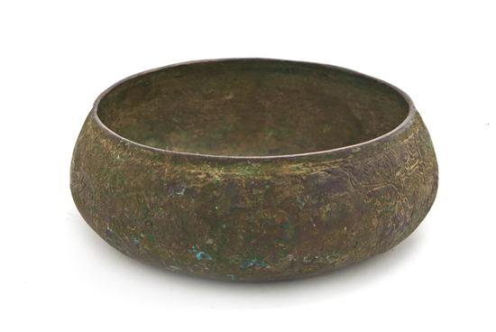 An Islamic Hammered Metal Bowl of low