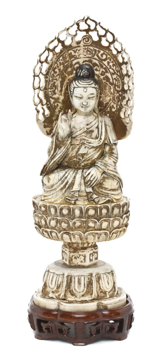 A Chinese Carved Ivory Model of Buddha