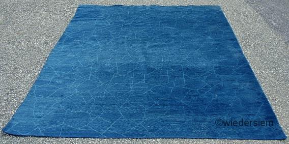 Blue contemporary carpet with incised