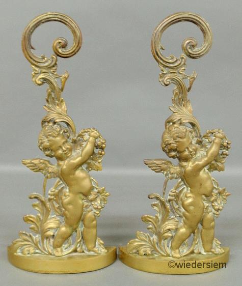 Pair of English brass cherub doorstops