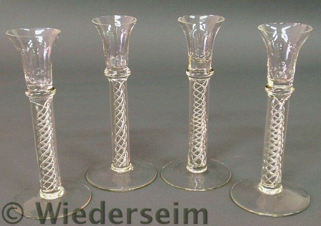 Set of four swirl glass candlesticks.