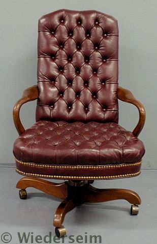 Red leather executive office chair labeled