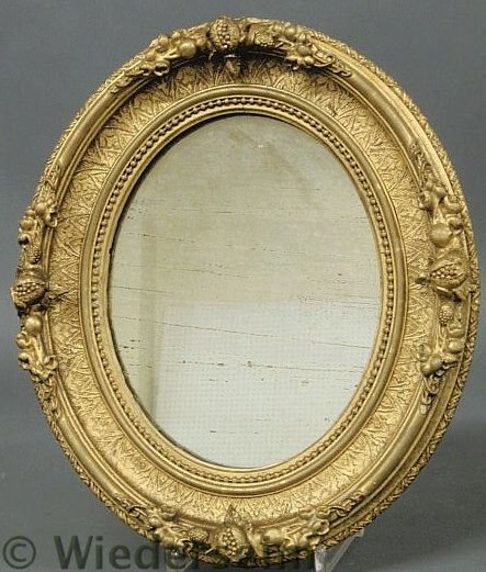 Oval mirror with gilt decorated