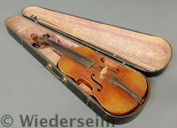 Wood cased maple violin labeled Stradivarius.