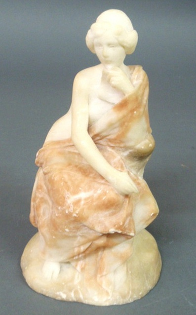 Carved marble statue of a seated and