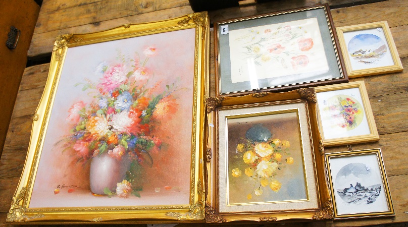 A collection of various framed paintings