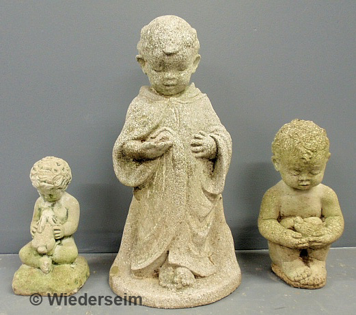 Three cast stone garden figures.