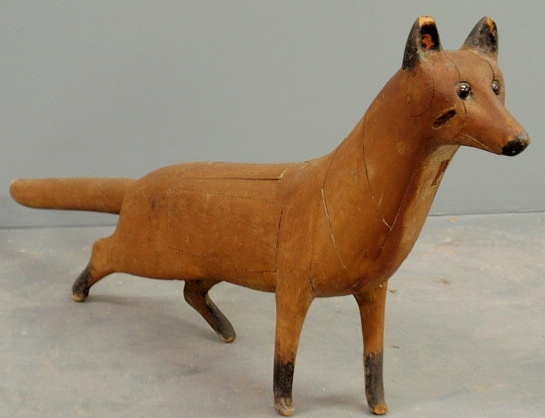 Carved wood standing fox with glass