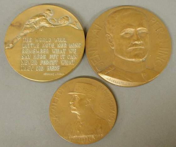 Three commemorative bronze medallions-