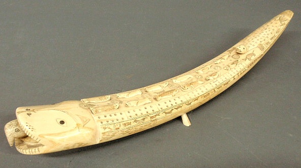 Walrus tusk carved into a cribbage board