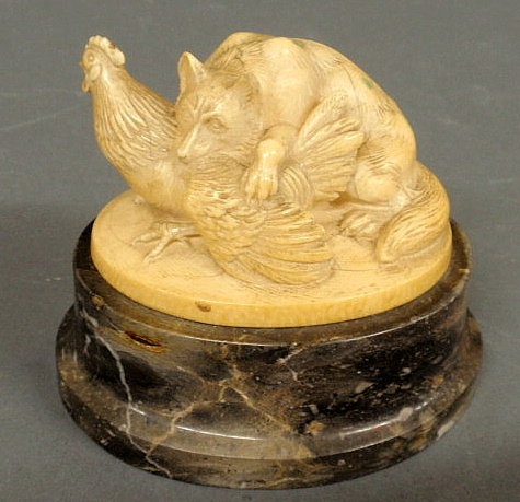 Carved ivory fox with chicken mounted