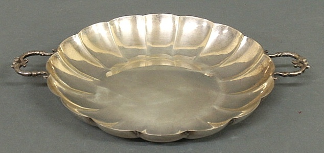 Sterling silver dish with scrolled handles.
